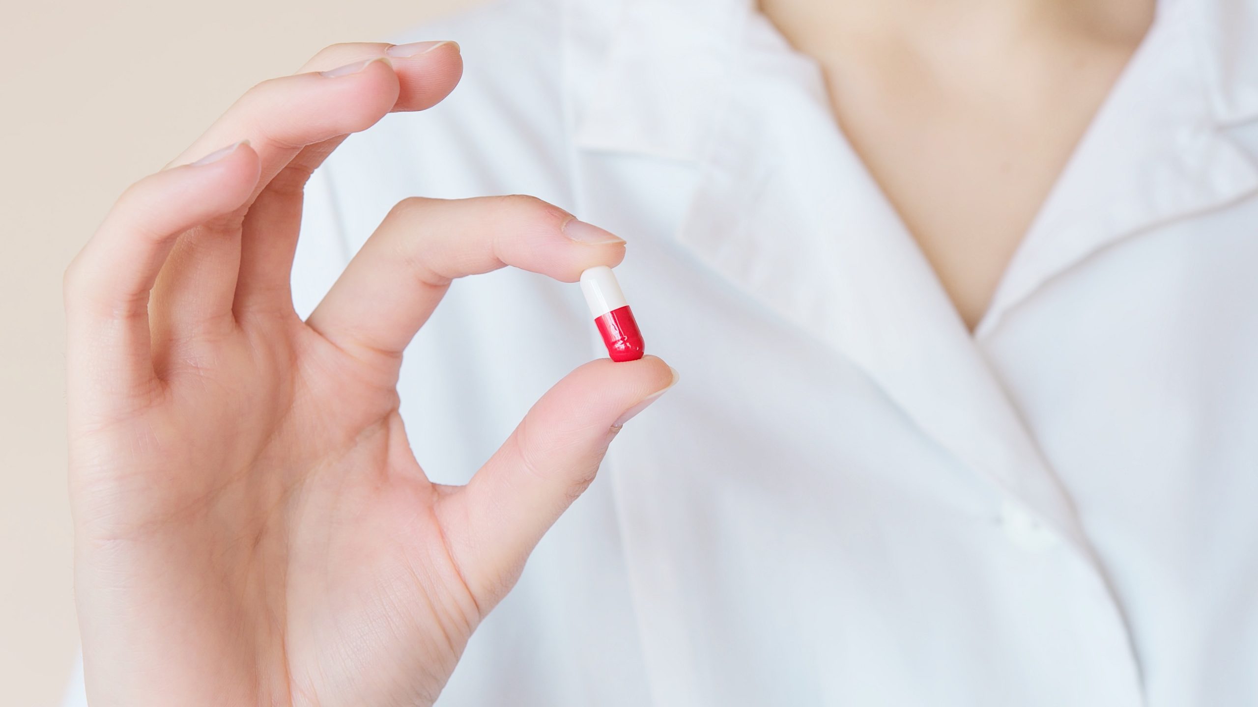 Pharmacist holding pill