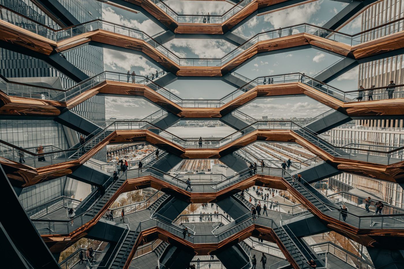 people stood in the window of a honeycomb building. 