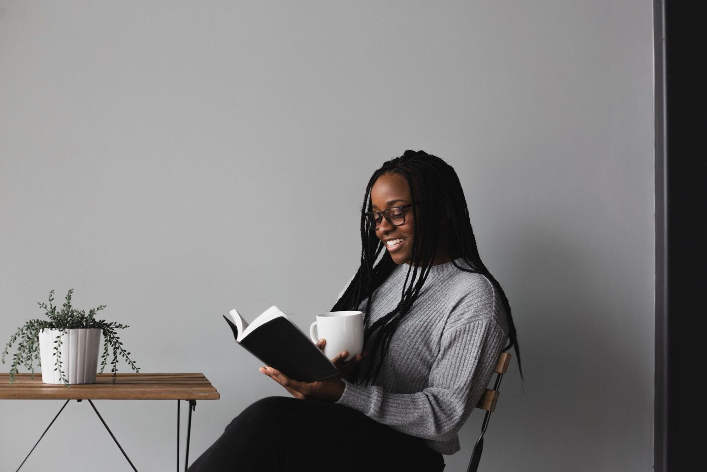 Lady reading a book with a coffee