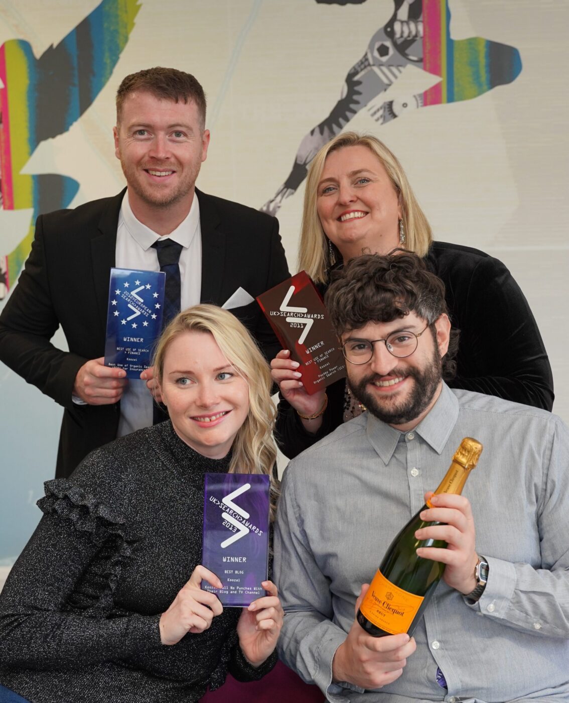 Award winning top SEO agency Koozai, team members holding some of their awards.