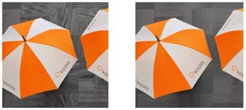Orange and white Koozai branded umbrellas photographed from above.