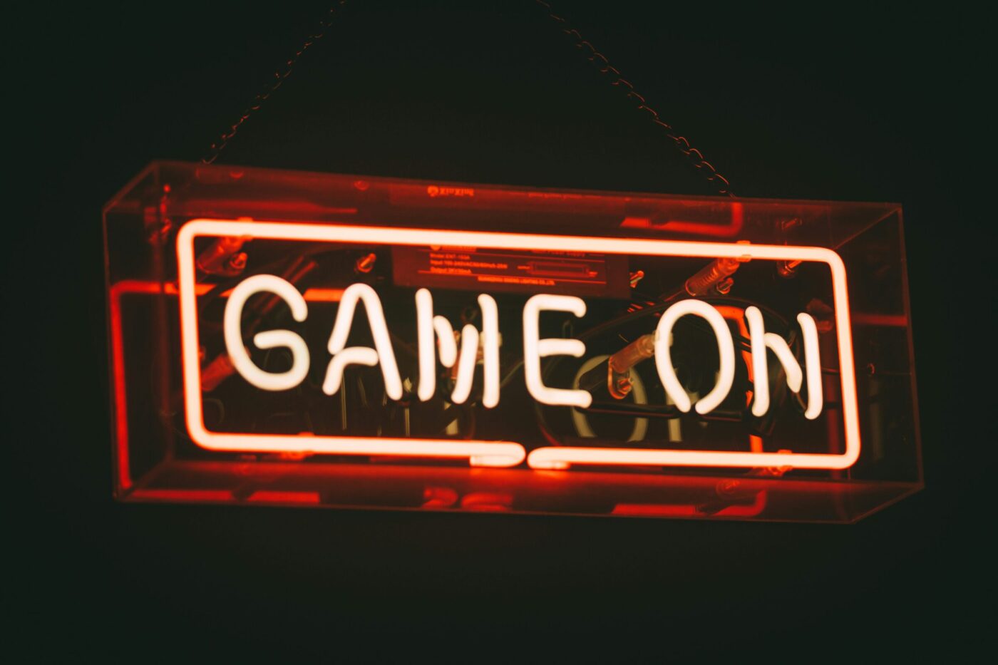 Red neon sign that reads 'Game On'